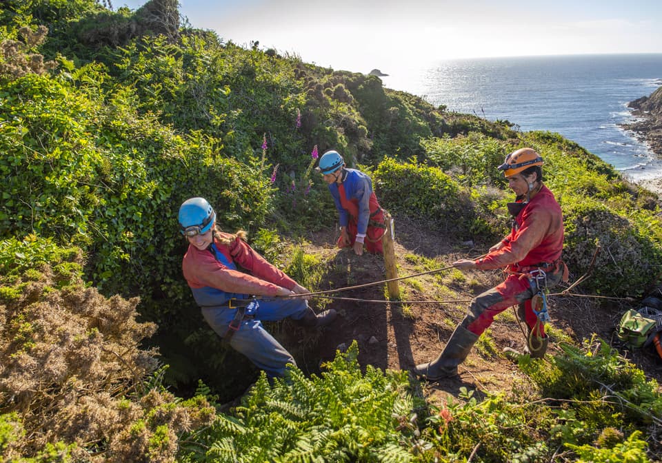 Mine explorers near St Just in Cornwall are being led underground by a caving instructor from Cornwall Underground Adventures