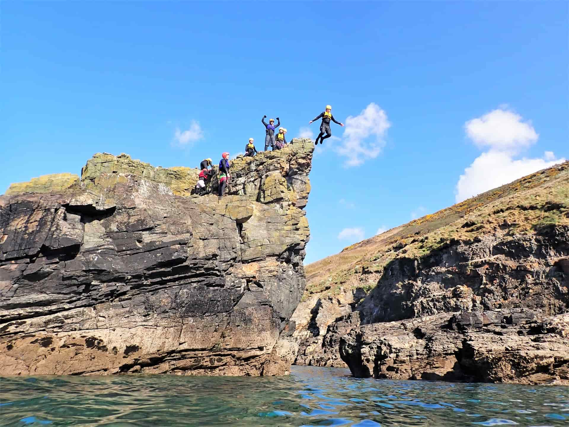 Cliff jumper at Praa sands doing one of the best jumps coasteering with Kernow Coasteering Cornwall