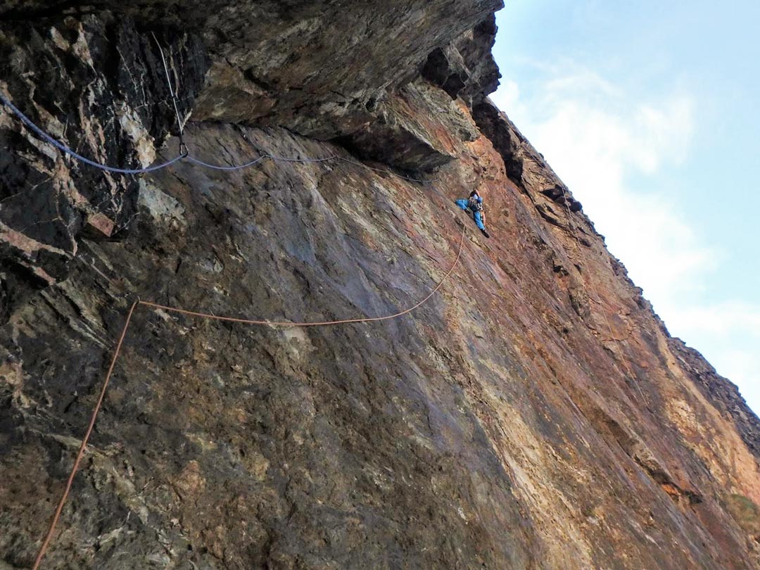 Climber makes a rising traverse up the ominous Mercury, E2, Carn Gowla, Cornwall