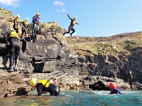 Medium sized cliff jump on a beginner coasteering session at Praa Sands, Cornwall