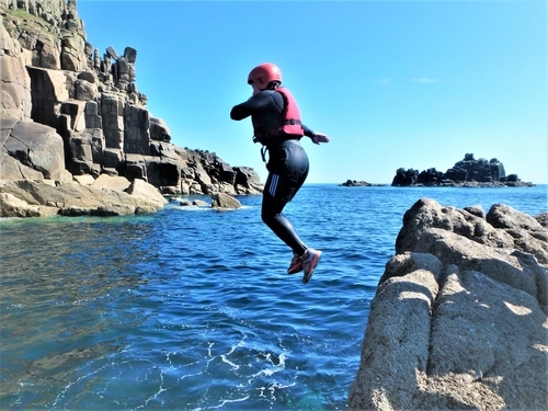 Coasteering at Land's End, Cornwall's most westerly point. Here a small cliff jump en route to bigger cliff jumps. Coasteering f