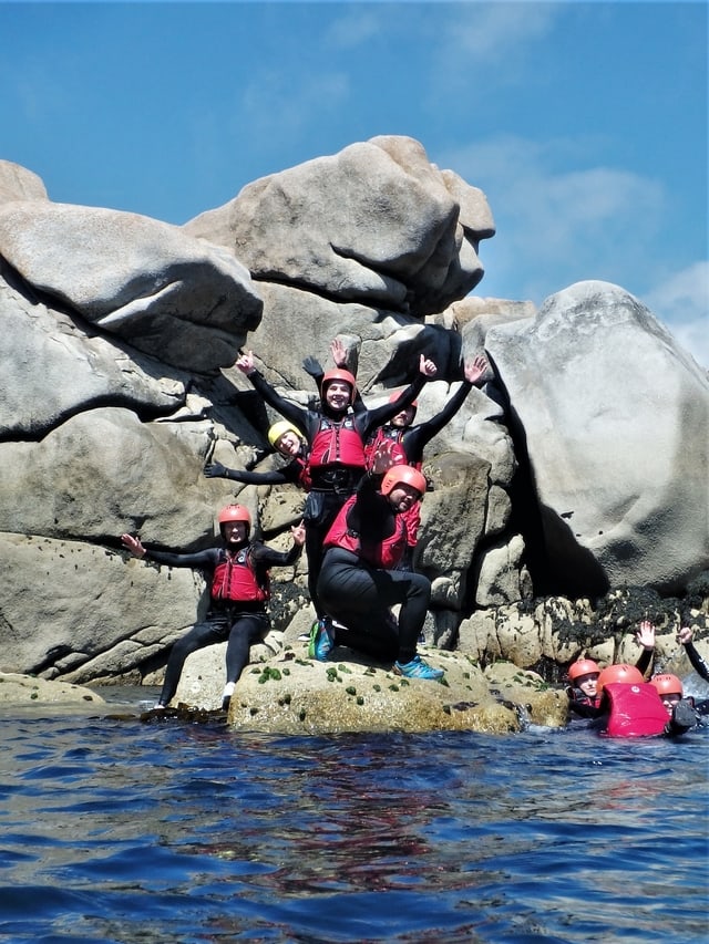 Coasteering group gathered in a rock on the isles of Scilly at Peninnis Head