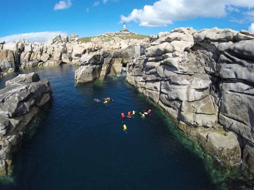 Drone shot of a group coasteering on the Isles of Scilly