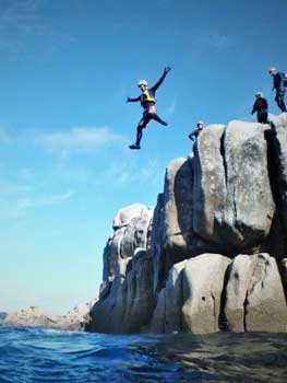 Kernow Coasteering guide jumping at Peninnis Head, Isles of Scilly. Cornwall and Isles of Scilly's best coasteering