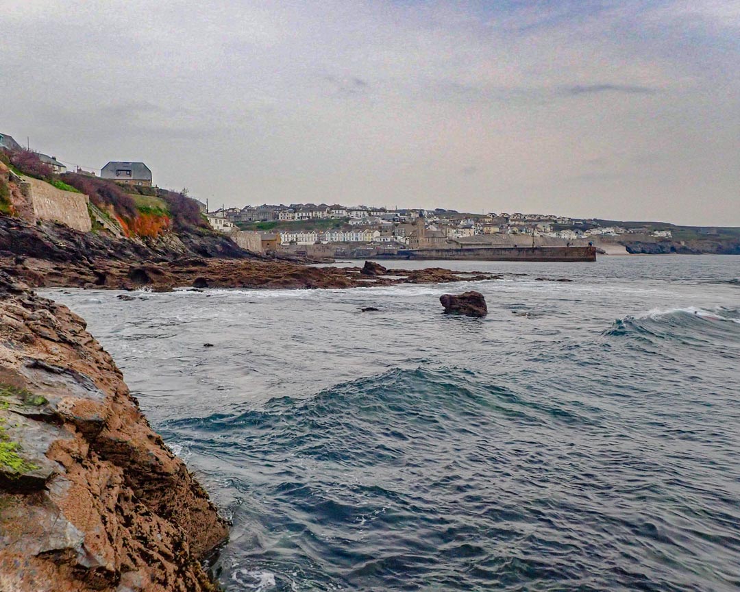 Finishing a coasteering exploration to Porthleven in Cornwall, view across Porthleven surf reef.