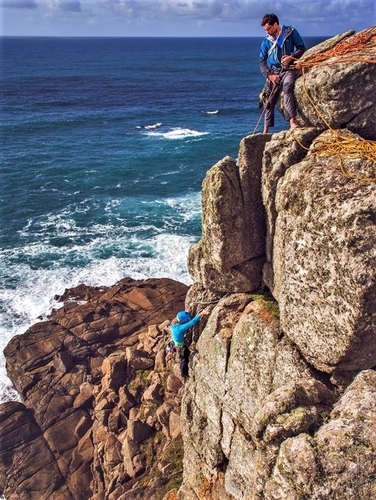 Climbers on a multi pitch rock climb at Carn Barra near Porthcurno and Land's End. Rock climbing instructors from Kernow Coastee