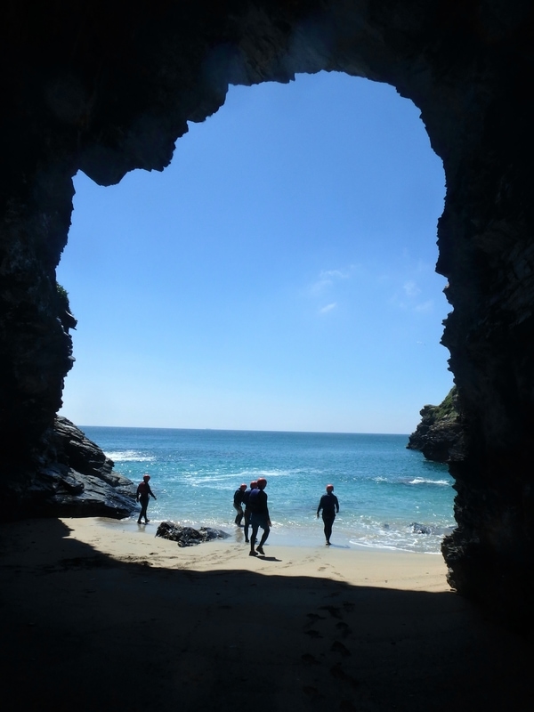 Coasteering group in Cornwall on a hidden beach with a massive sea cave. An experience with Kernow Coasteering, Cornwall coastee