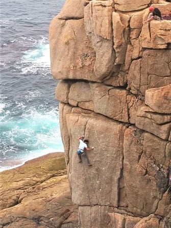 Kernow Coasteering climbing instructor leading Demolition, E6 at Sennen, Cornwall.