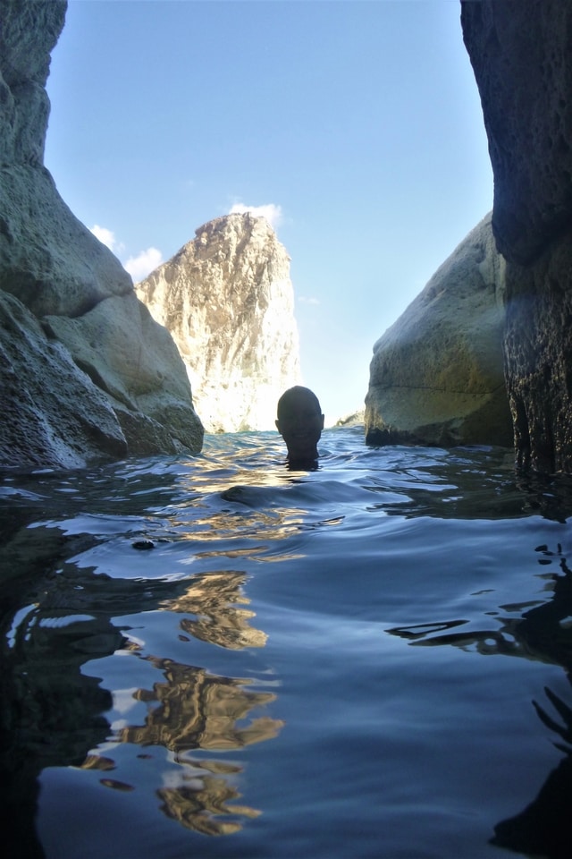 Kernow Coasteering exploring a cave in Santorini, Greece