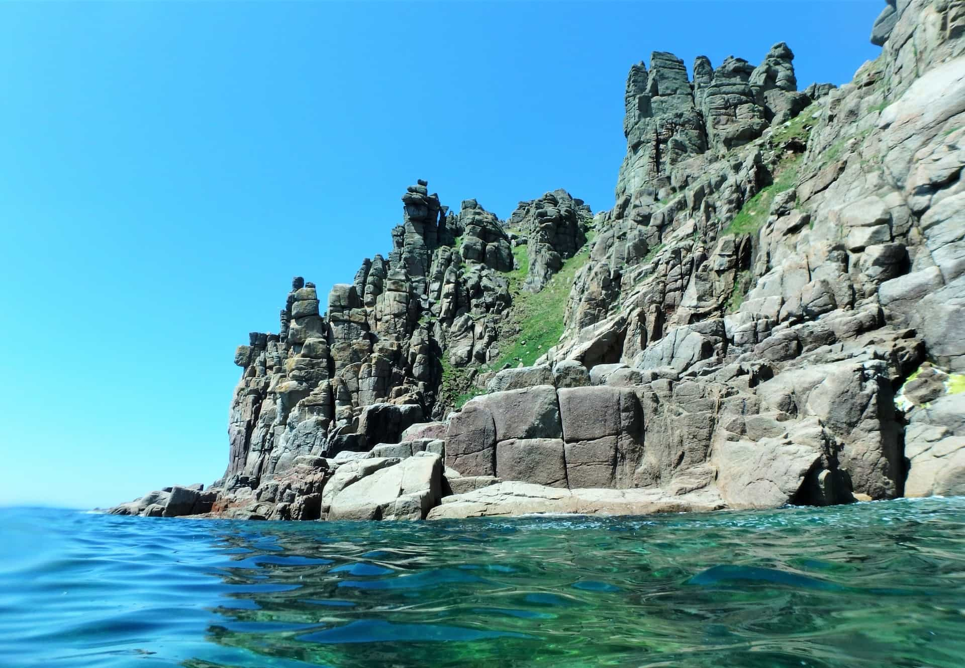 Huge granite cliffs at Pordenack Point, Cornwall. As seen from sea level, whilst coasteering