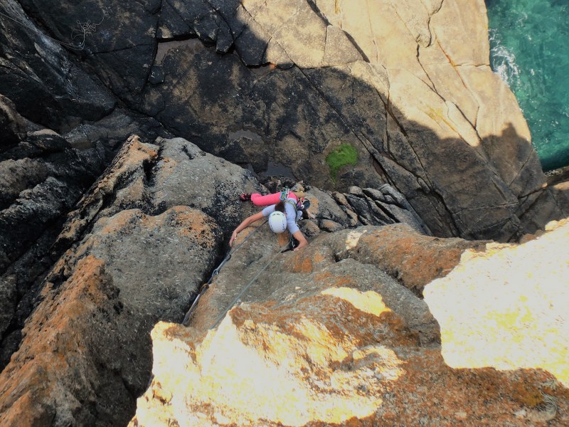 Climber on Civvy Route, HS, at Sennen during an intermediate rock climbing course with Kernow Coasteering