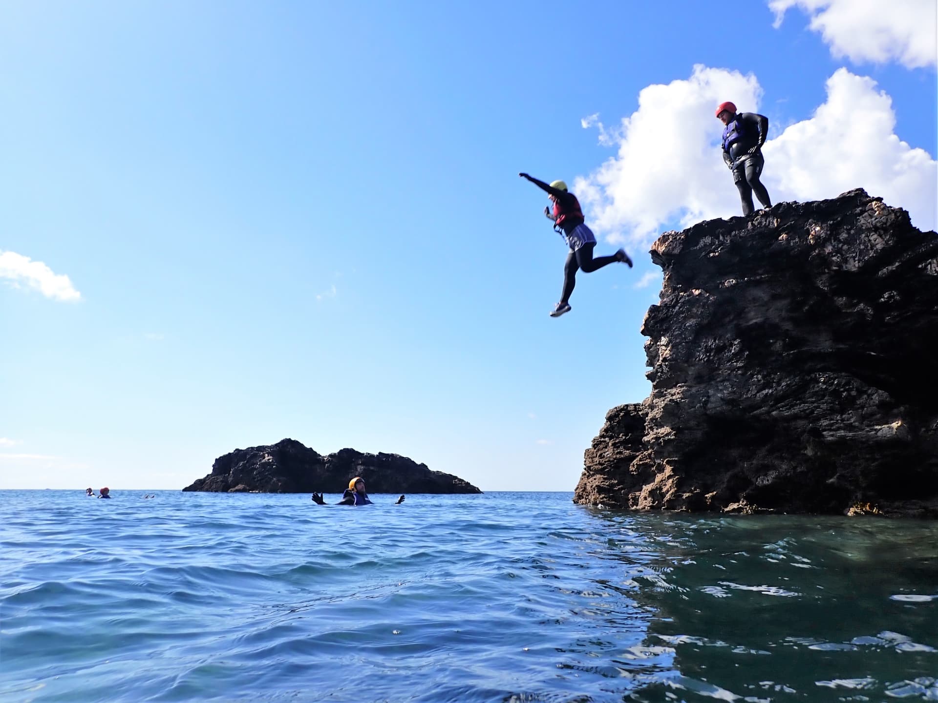 Jumping between the many small islands that make up coasteering at Praa Sands with Kernow Coasteering in Cornwall