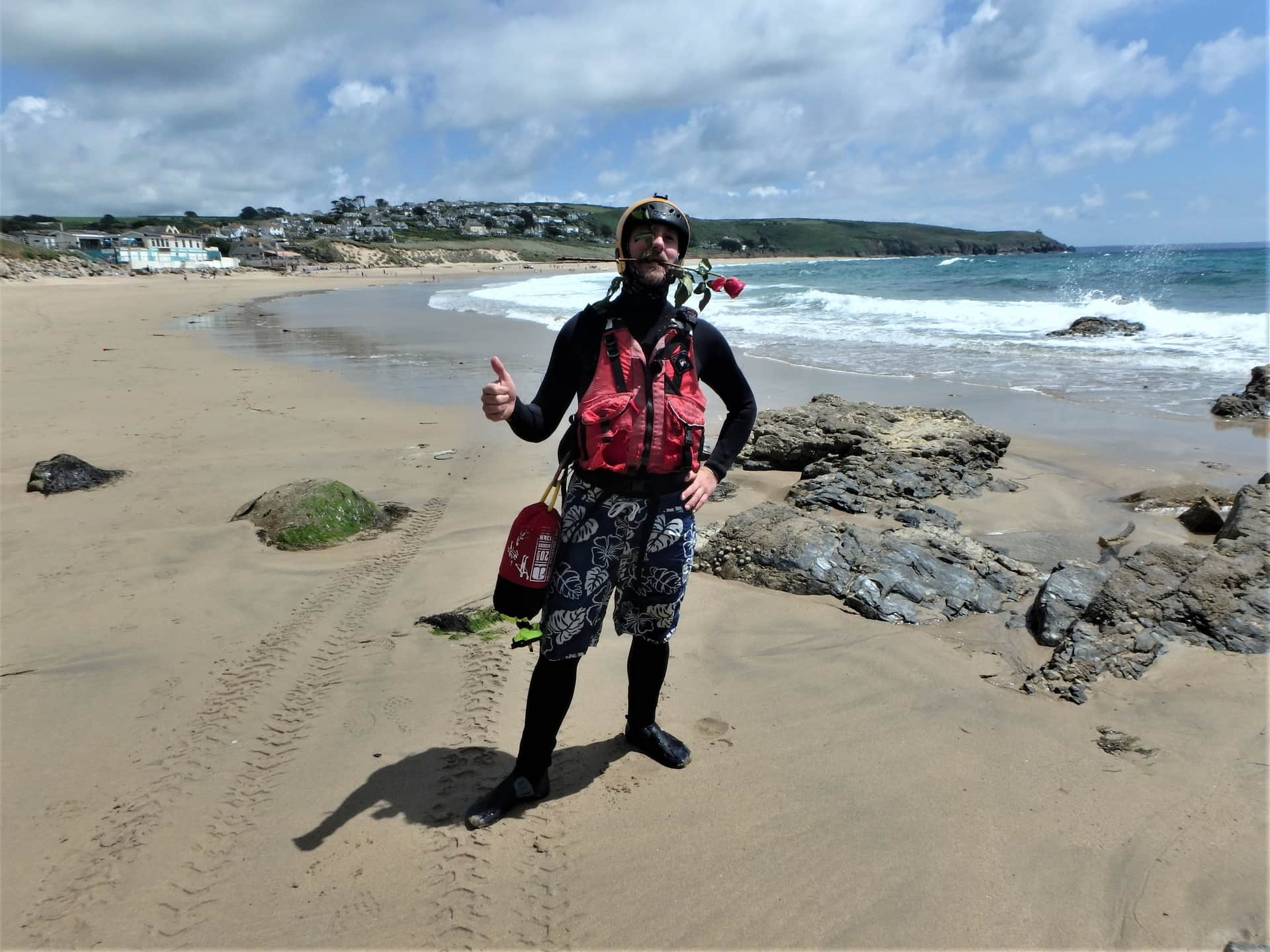 Coasteering guide on beach at Praa sands, Cornwall, ready for a session with Kernow Coasteering