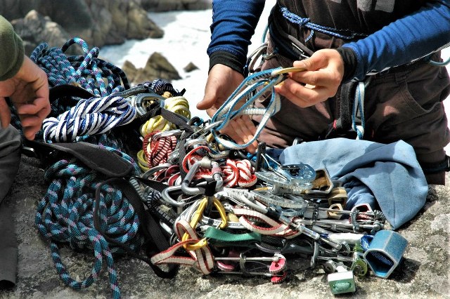 Rock climbers preparing their equipment for multi pitch trad climbing