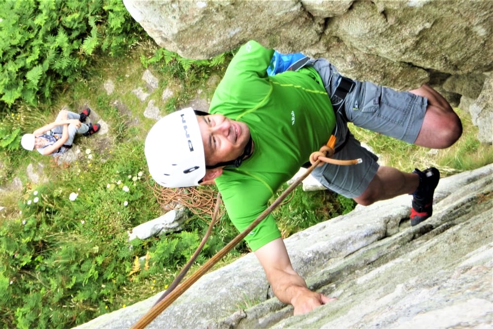 Rock climber on the Groove at Trewavas Head. Rock climbing courses in Cornwall with Kernow Coasteering.
