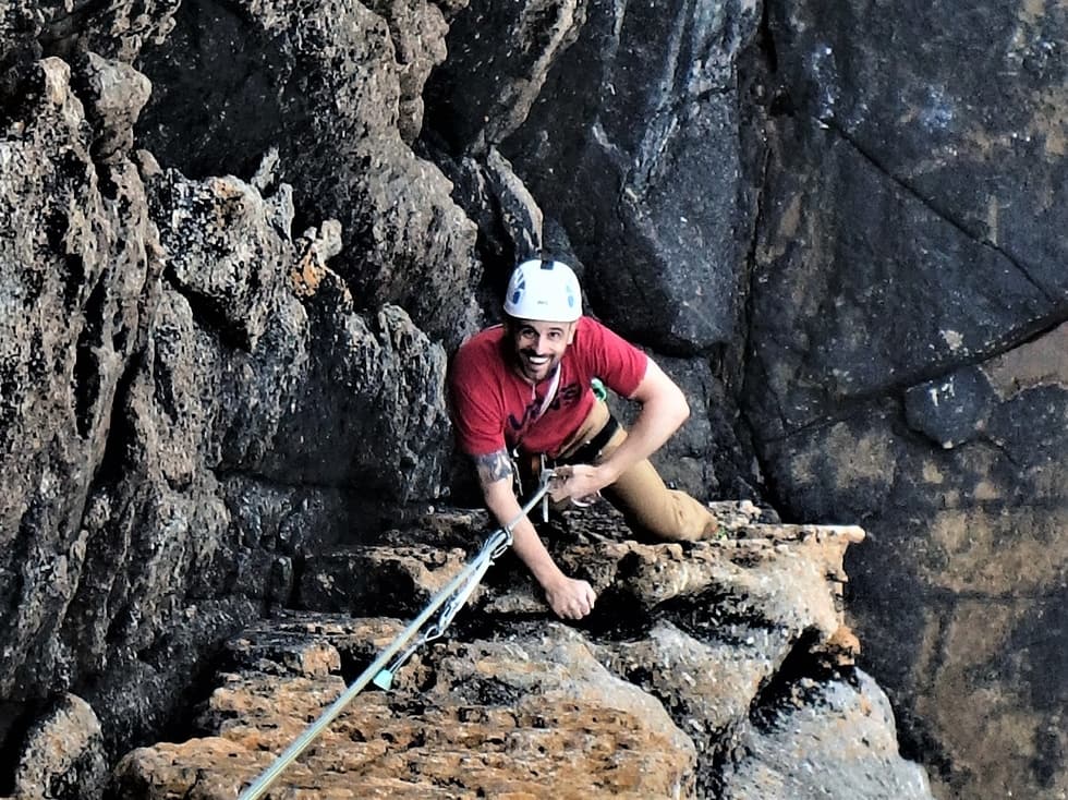 Rock CLimber on the route Staircase during an intermediate climbing course at Sennen.