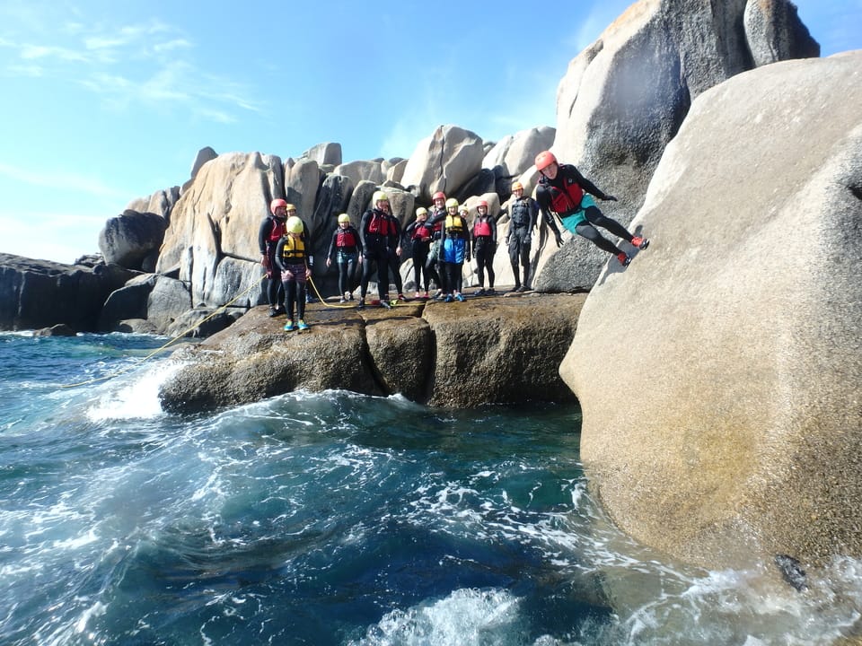 Running across a granite wall coasteering at Peninnis Had on the Isles of Scilly