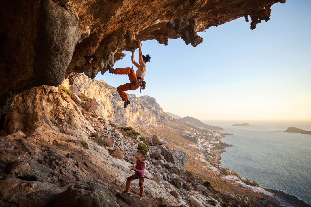 Woman Climber Fully Equipped for Sport Climbing on a Steep Cave Route