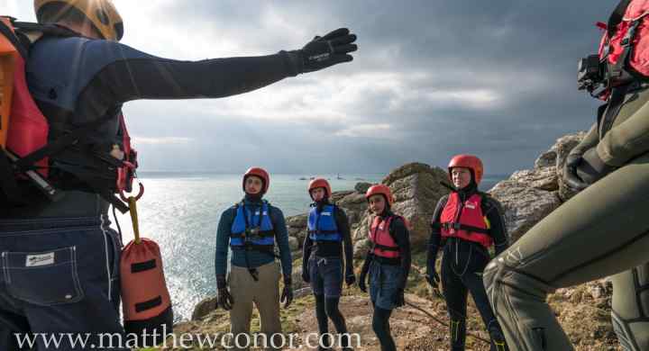 Coasteering instructor gives a safey briefing to a group before a coasteering session in west Cornwall with Kernow Coasteering