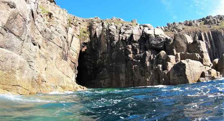 Coasteering into a Huge Sea Cave at Dutchman's Zawn, Land's End , Cornwall. 