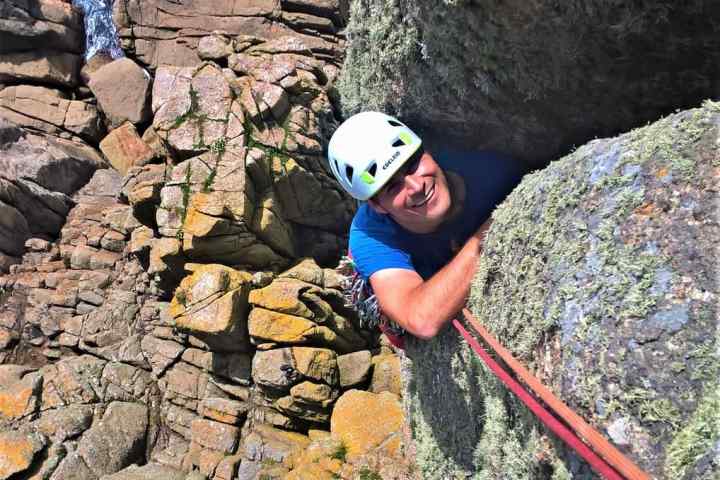 Rock climber at Chair Ladder on a Kernow Coasteering rock climbing course. Learn to climb in Cornwall with kernow Coasteering.