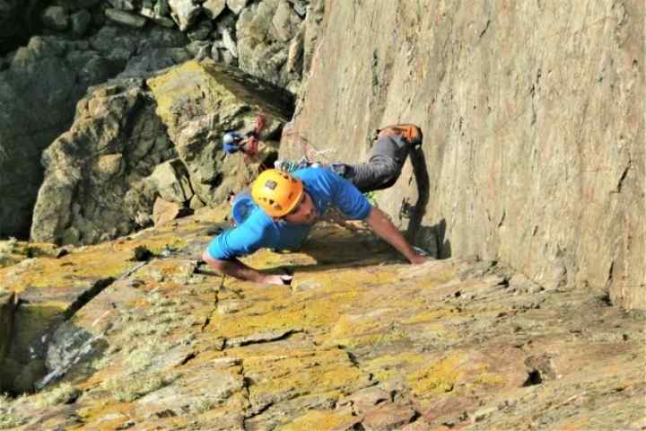 Kernow Coasteering climbing instructor rock climbing near Cape Cornwall, St. Just, Cornwall. Kendijack Cliff, the route is Thane