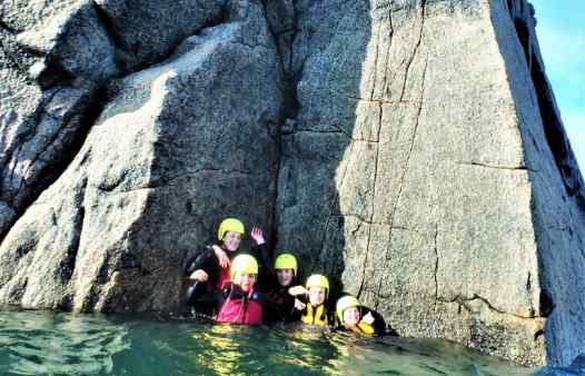 Group gathered a sunken ledge coasteering at Peninnis Head, St. Mary's