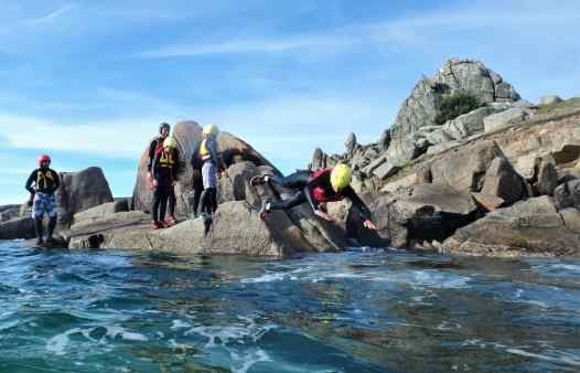 Coasteere making an enthusiastic start to a coasteering session on the Isles of Scilly