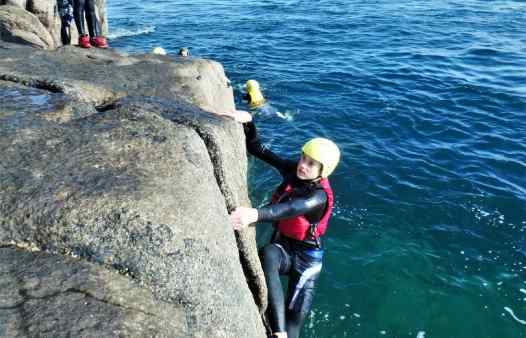 Climbing the golden granite of Scilly on a coasteering session