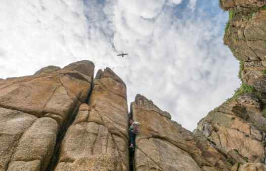 Crack climbing at Porthcurno in Cornwall