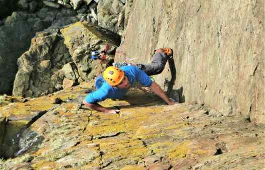 Rock climber on Thane, E1 at Kenidjack, a rock climbing route in Cornwall