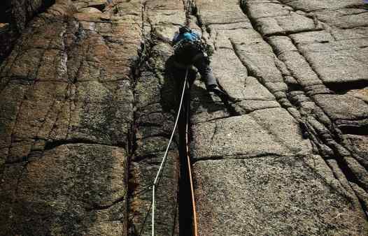 Rock climbing at Land's End on a Kernow Coasteering Cornwall rock climbing course
