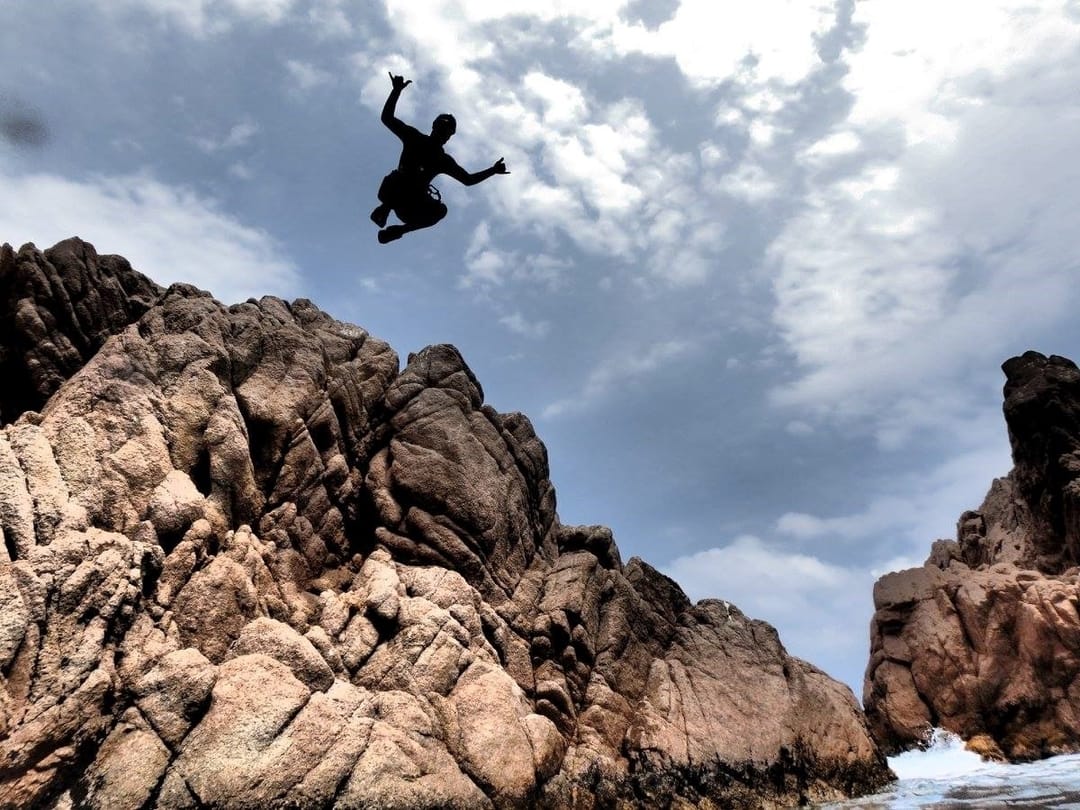 Cliff jump during coasteering on the Costa Brava, Spain with Aventura Experience