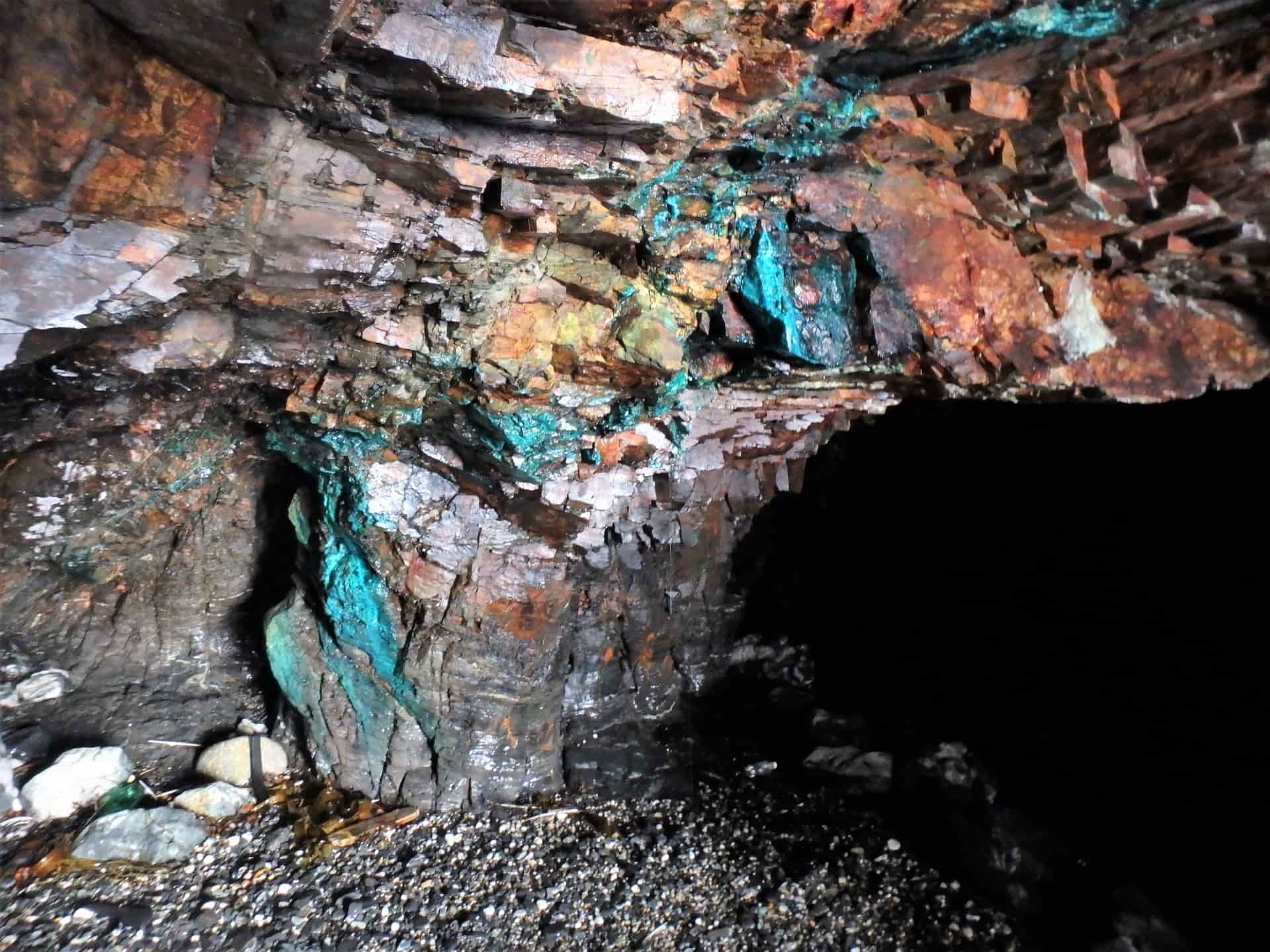 Blue and green copper minerals inside a sea cave near Praa Sands