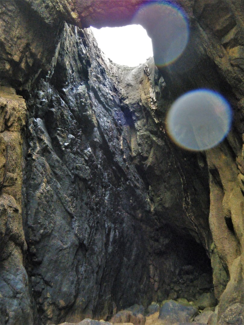 Looking up through Funnel Hole at Gwennap Head, one of the most dramatic sea caves in Cornwall.
