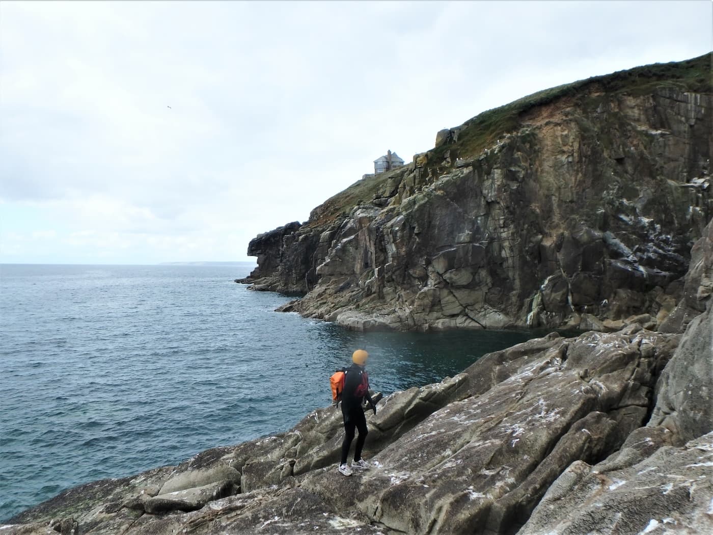 Exploring the sea caves beneath Rinsey Head near Praa Sands on a coasteering adventure.