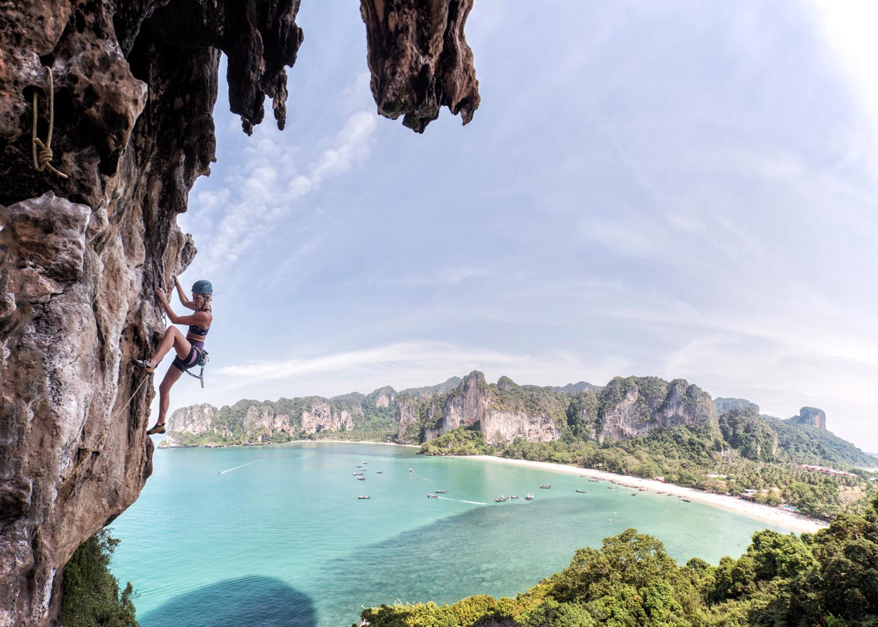 Woman sport climbing at Thaiwand Wall, Krabi, Thailand