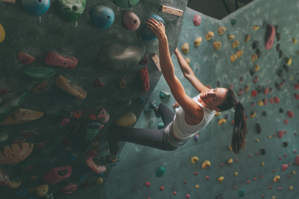 Woman Climbing on an Indoor Climbing Wall