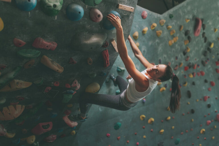 Woman Climbing on an Indoor Climbing Wall
