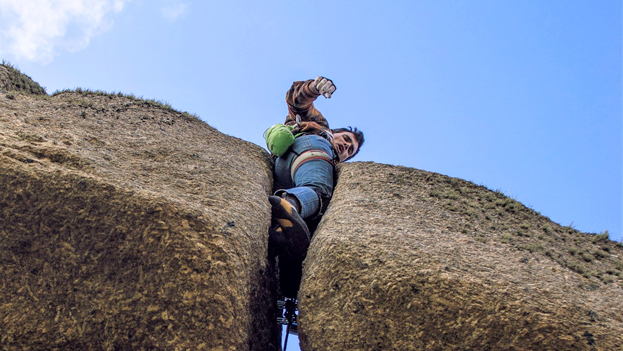 Climber tackling the off-width crack of Jack Yer Body (E4 5c) in West Cornwall