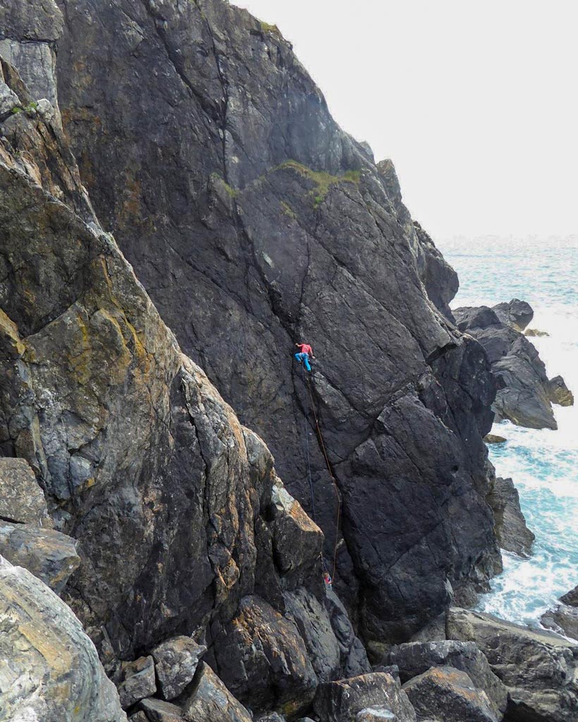 Climber on Edge of Darkness, E1, at the Lizard Peninsula during a guidebook photoshoot.