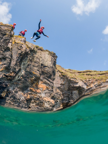 Cliff jumping near Praa Sands beach on a session of guided coasteering in Cornwall – things to do in Porthleven and St Ives.