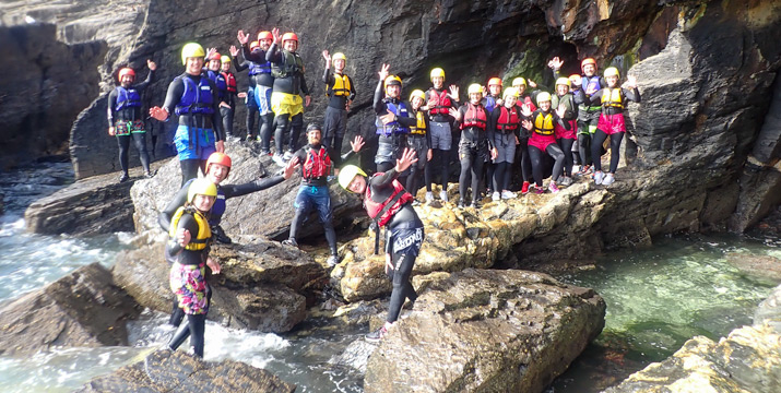 Group photo on the rocks after exploring sea caves at Praa Sands.
