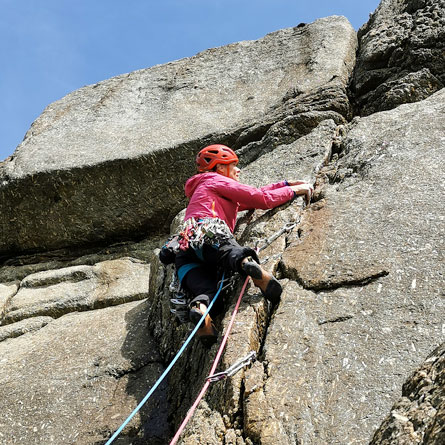 A climber leads Dialectic at Carn Barra, expertly navigating the steep granite sea cliffs of west Cornwall