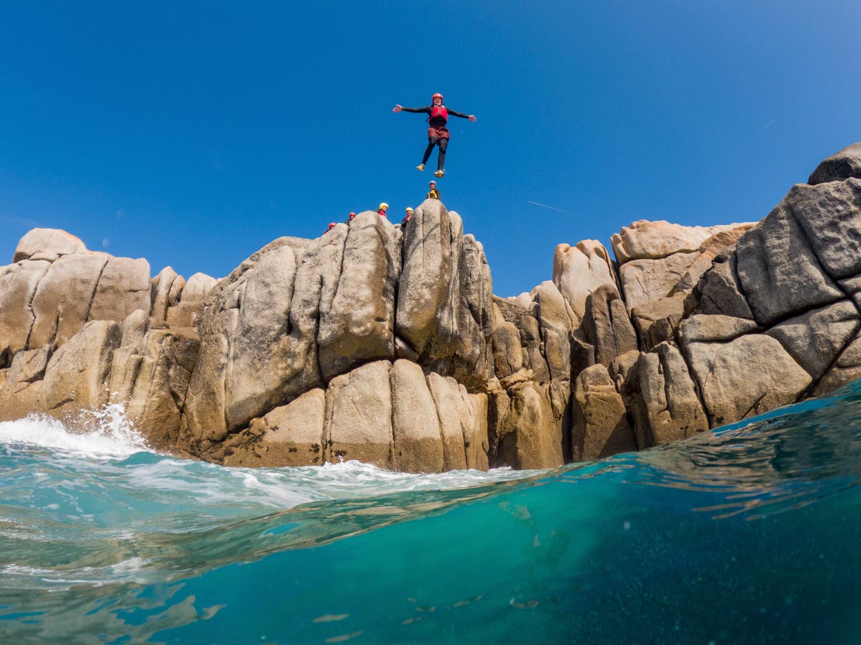 Stupendous cliff jump into the wild Atlantic waters near Hugh Town, Scilly Isles