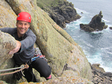 Climber enjoying sea cliff routes at Sennen, one of the most scenic spots for climbing Cornwall