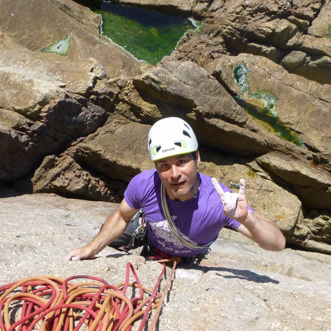Climber reaching the end of pitch 1 of Bishop's Rib, E1, at Chair Ladder, a challenging multi-pitch route in Cornwall.