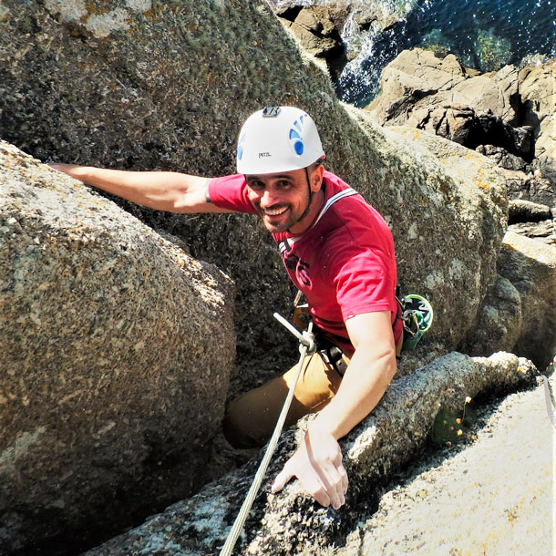 Climber smiling after seconding on Civvy Route, a well-loved HS climb at Sennen.