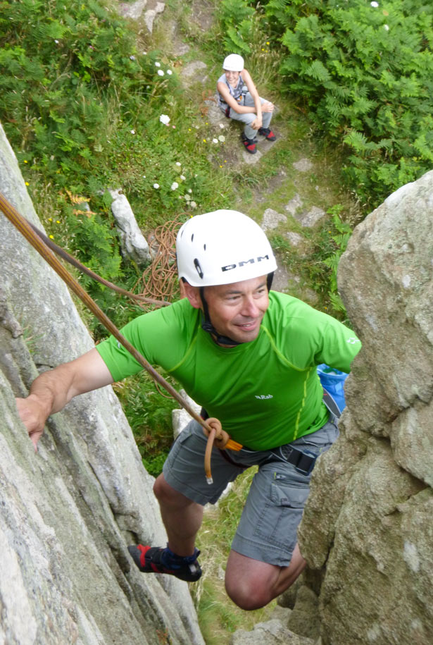 Adult climber enjoying a relaxed route on the granite cliffs of Cornwall