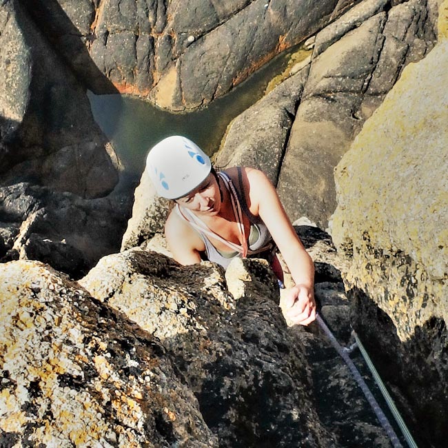 A climber seconding her first traditional route on the granite cliffs of West Cornwall